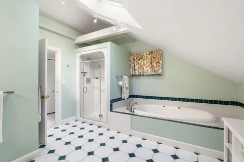 a bathroom with a bathtub and a shower