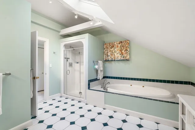 a bathroom with a bathtub and a shower