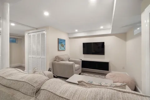 a bedroom with furniture and a flat screen tv