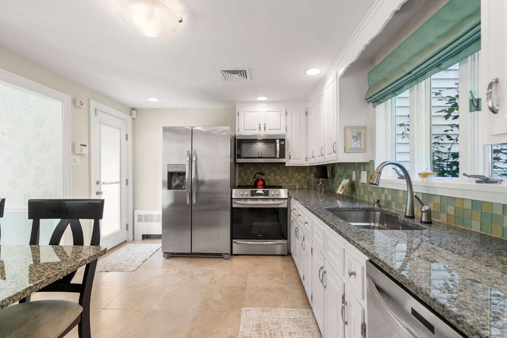 5 Halcyon Road Newton, MA 02459 - Photo 10 of 26 a large kitchen with granite countertop a large counter top stainless steel appliances and a sink