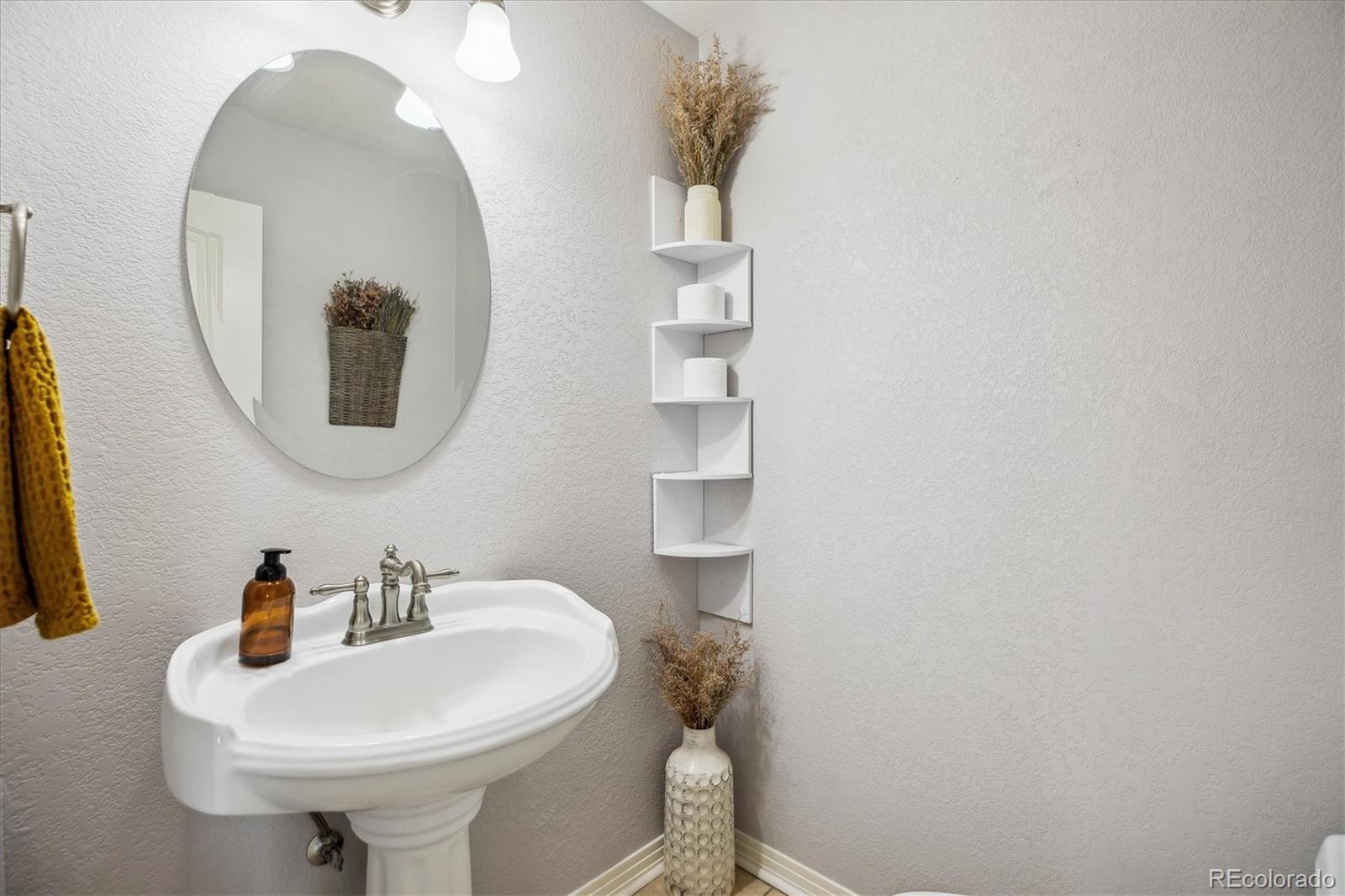 645 Yuma Loop, Unit 103 Kiowa, CO 80117 - Photo 12 of 23 a bathroom with a sink and a mirror
