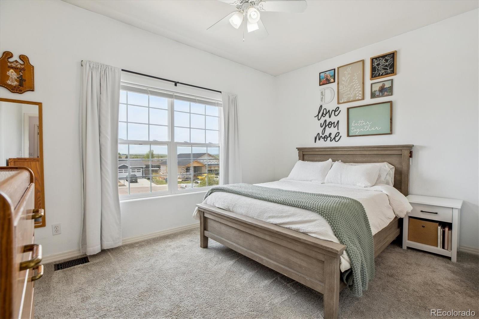 645 Yuma Loop, Unit 103 Kiowa, CO 80117 - Photo 13 of 23 a bedroom with a bed and a window