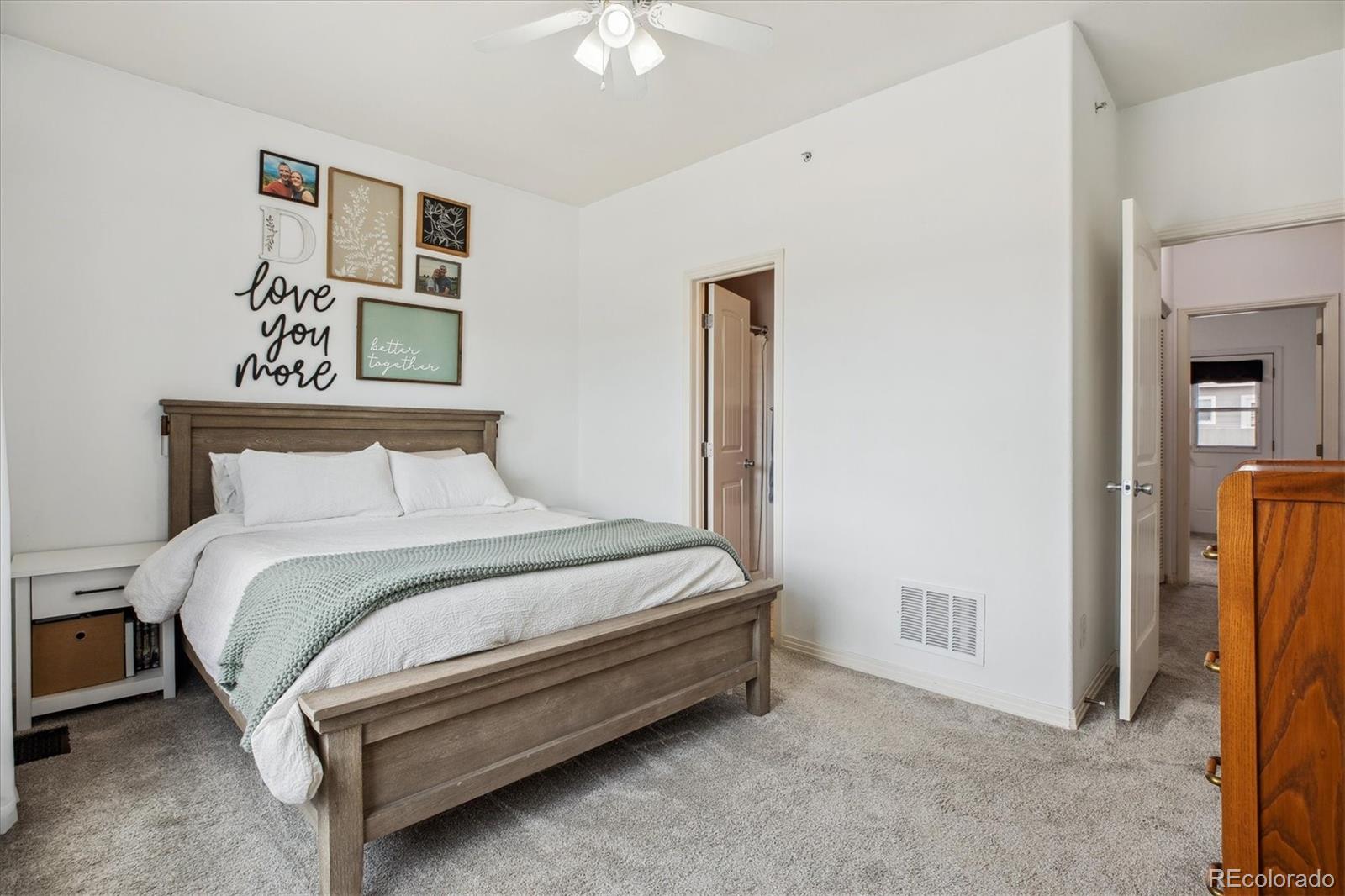 645 Yuma Loop, Unit 103 Kiowa, CO 80117 - Photo 14 of 23 a bedroom with a bed and a chandelier
