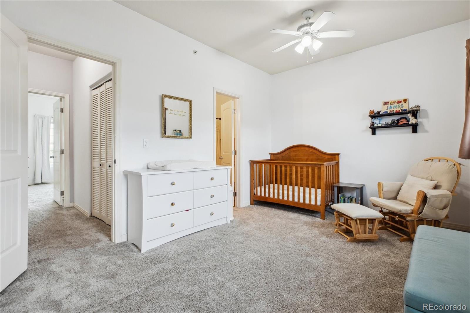 645 Yuma Loop, Unit 103 Kiowa, CO 80117 - Photo 16 of 23 a spacious bedroom with a bed and a walk in closet