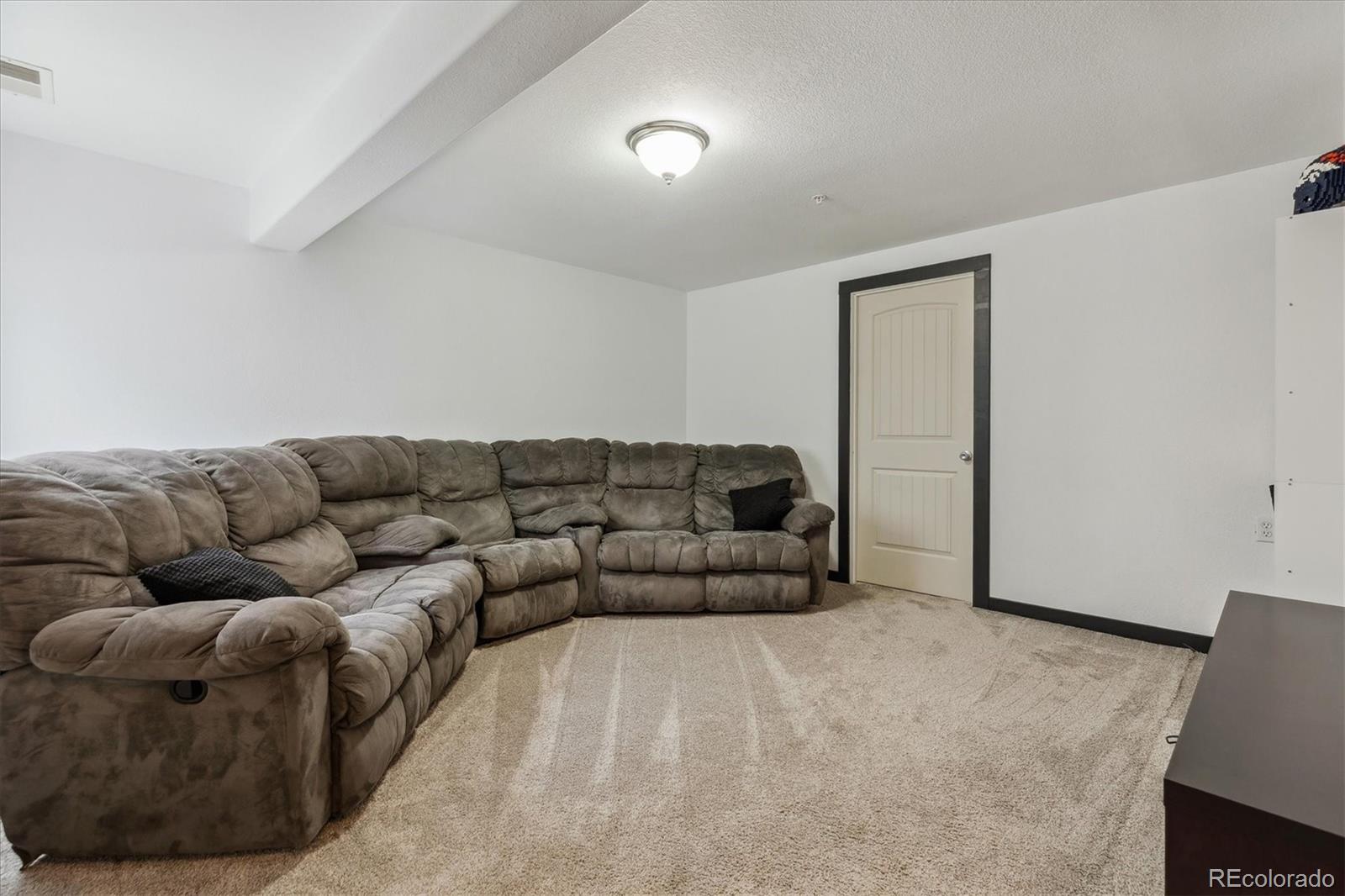645 Yuma Loop, Unit 103 Kiowa, CO 80117 - Photo 19 of 23 a living room with furniture and a couch