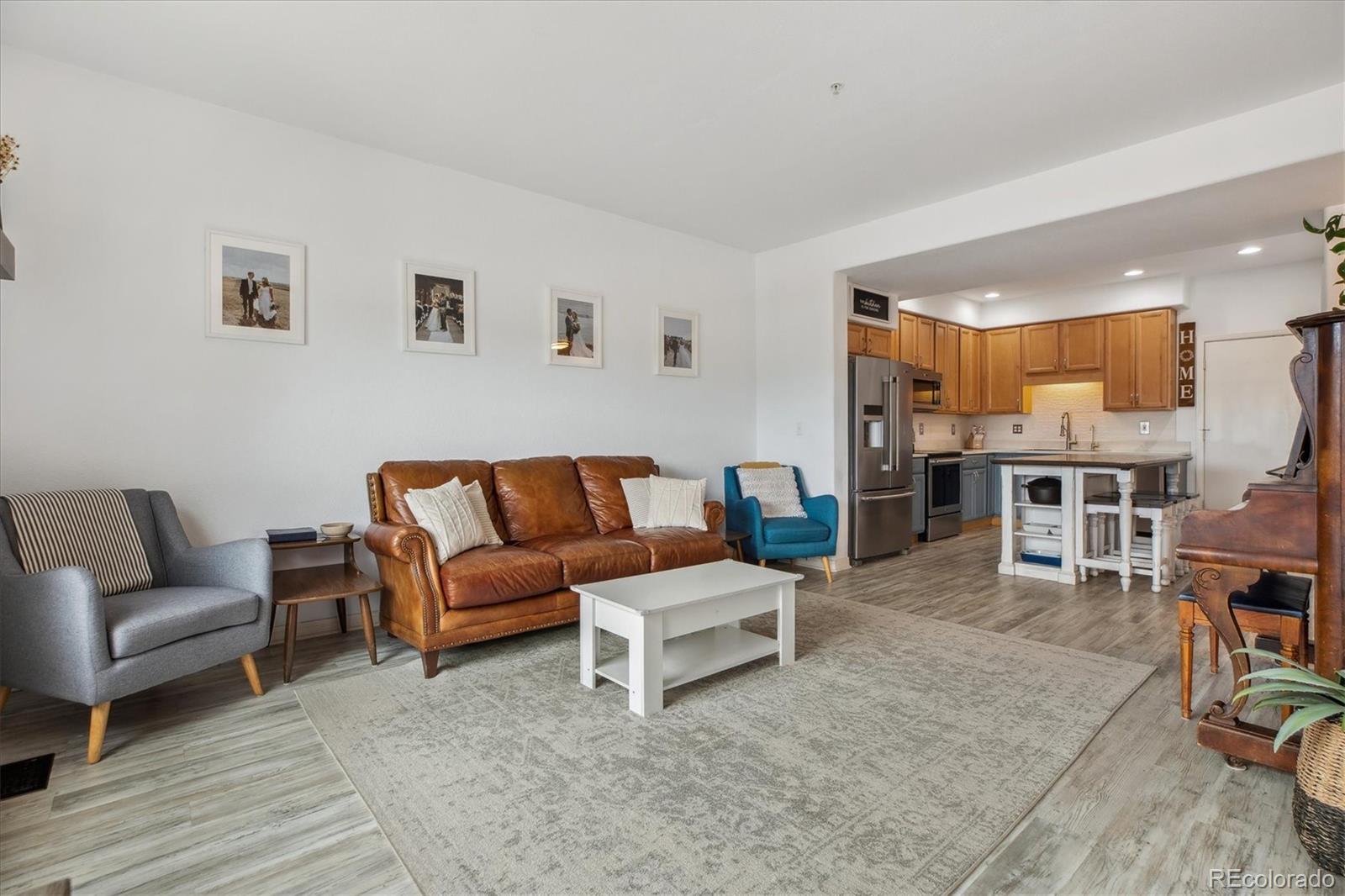 645 Yuma Loop, Unit 103 Kiowa, CO 80117 - Photo 5 of 23 a living room with furniture and a wooden floor