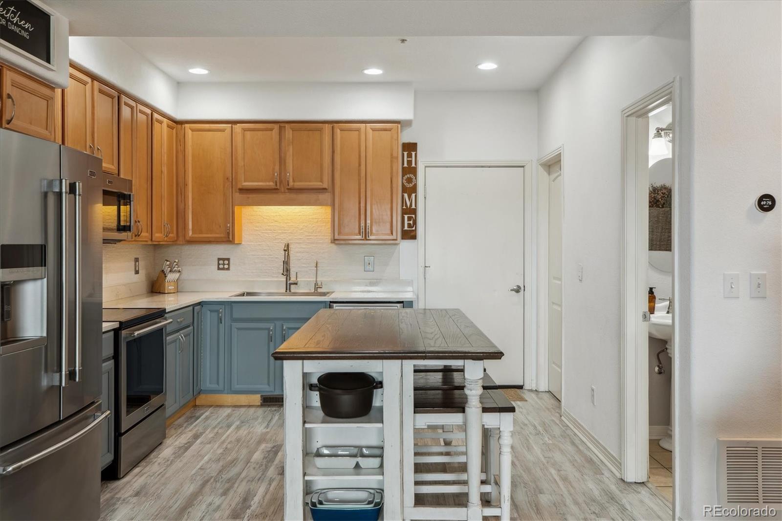 645 Yuma Loop, Unit 103 Kiowa, CO 80117 - Photo 8 of 23 a kitchen with kitchen island granite countertop a sink stove and refrigerator