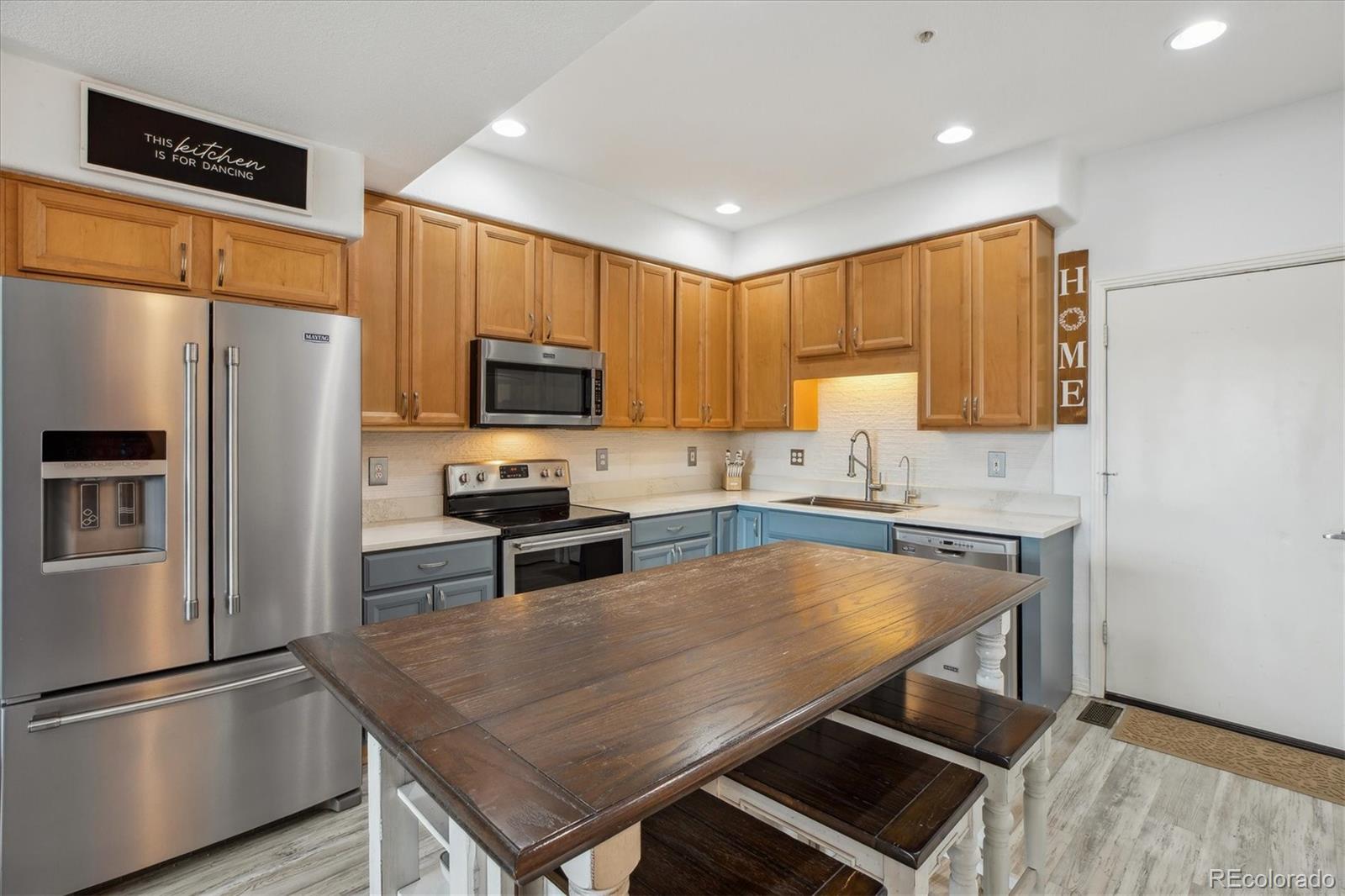 645 Yuma Loop, Unit 103 Kiowa, CO 80117 - Photo 9 of 23 a kitchen with a refrigerator a stove a sink and a refrigerator