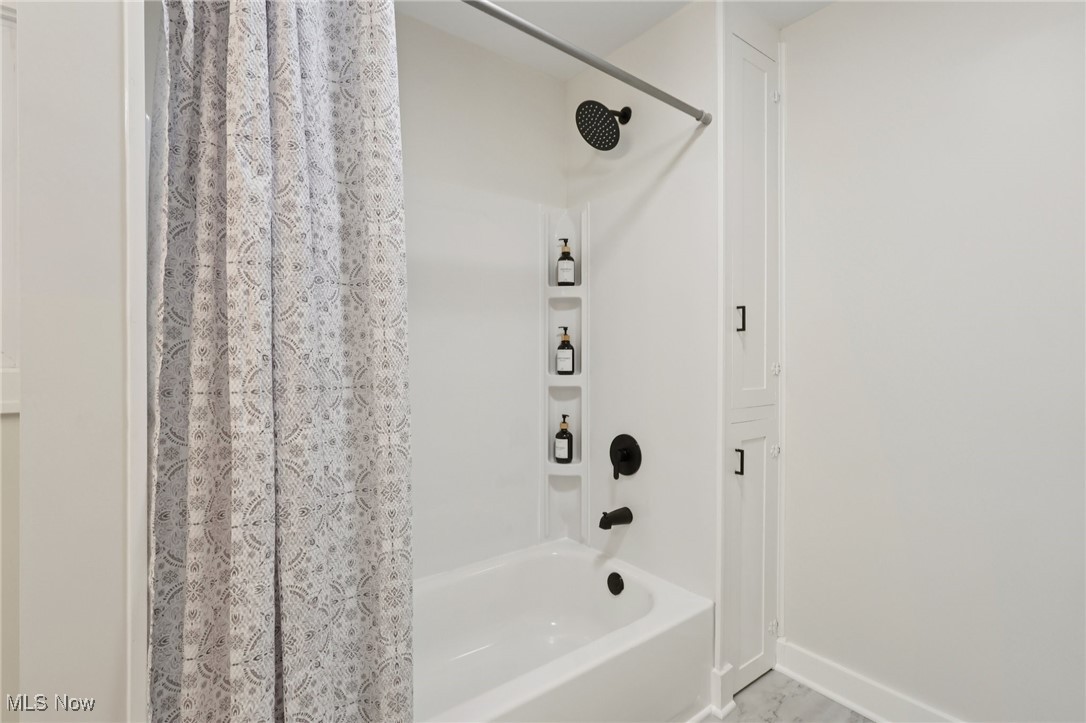 548 Spring Street Wooster, OH 44691 - Photo 16 of 45 Bathroom with shower / bathtub combination with curtain and baseboards