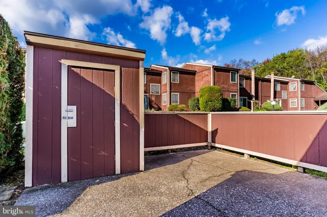 a view of backyard with a large tree