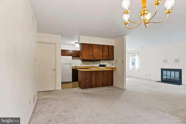 a view of kitchen with microwave refrigerator and stove