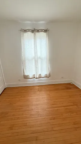 a view of room with wooden floor and door