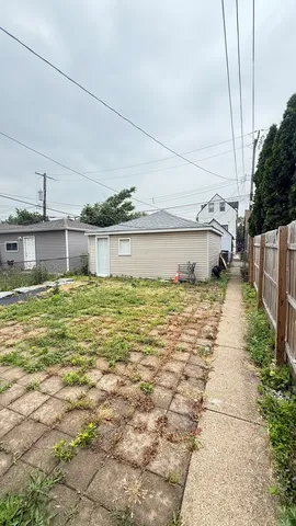 a view of a house with a wooden fence