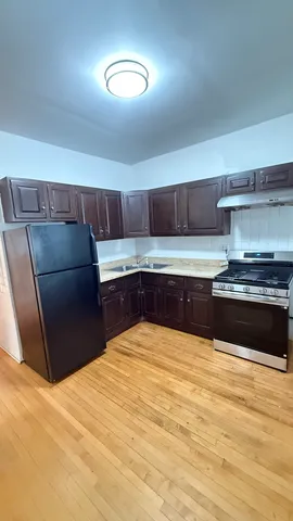 a kitchen with a sink and a stove top oven