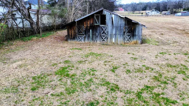 a backyard of a house with a yard and trees