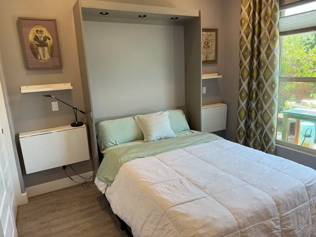 a bedroom with a bed and a window