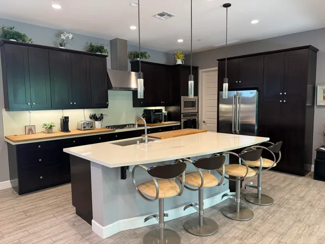 a large kitchen with a table and chairs