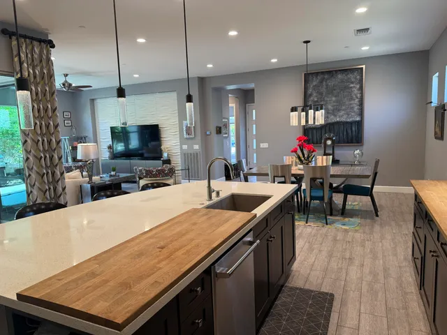 a kitchen with kitchen island a sink stove and wooden floor