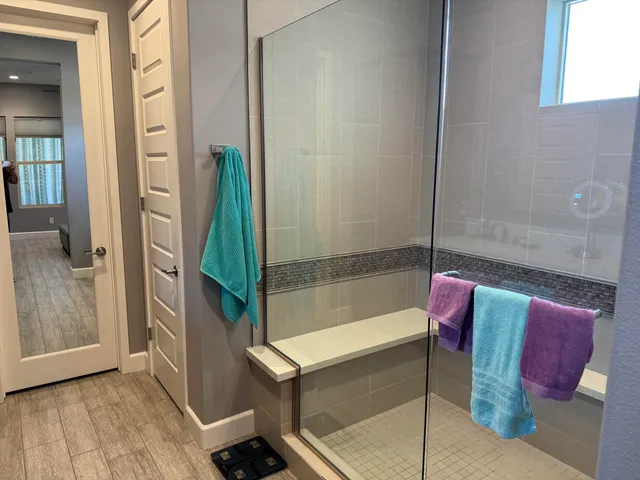 a bathroom with a tub shower vanity and a sink