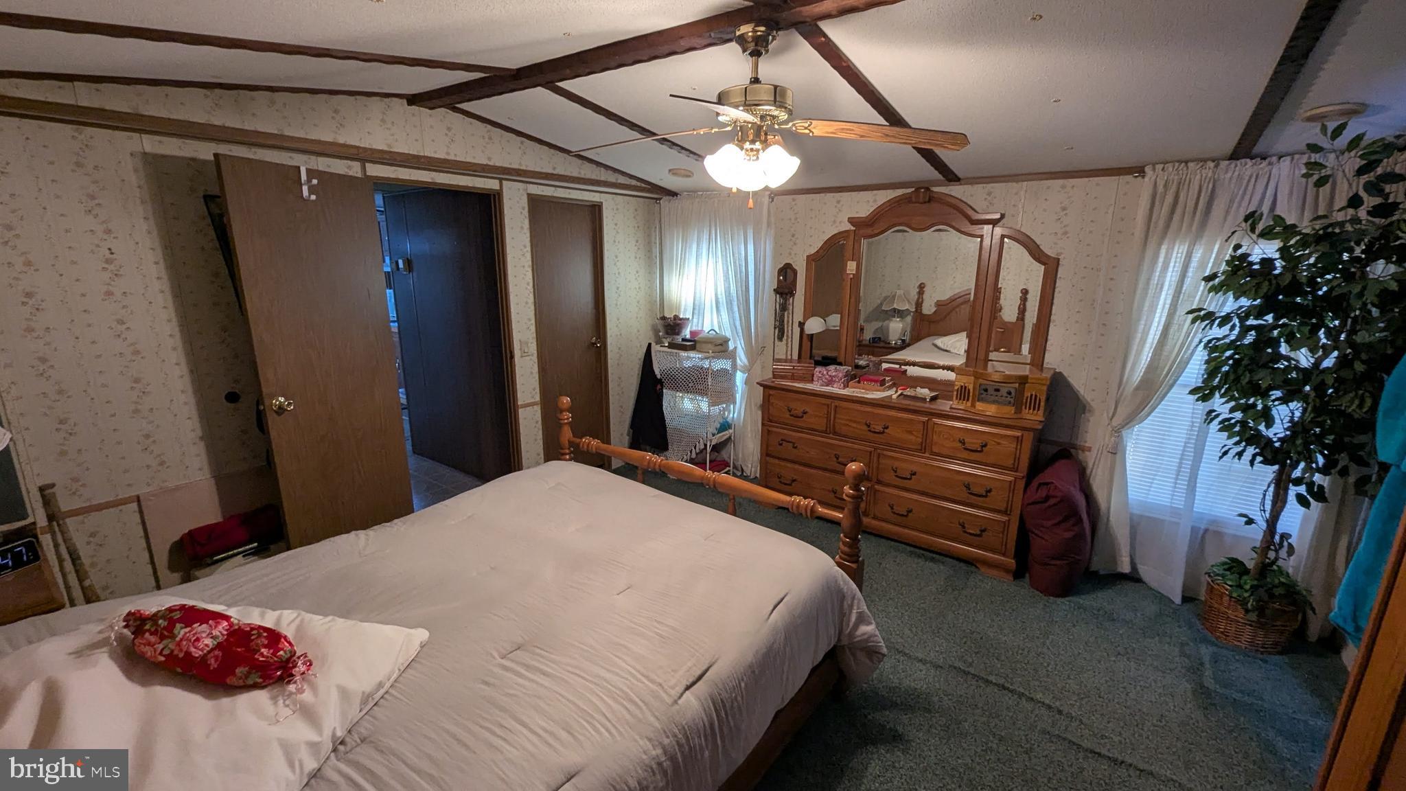 9625 Airport Road Seaford, DE 19973 - Photo 12 of 31 a bedroom with a bed and a chandelier