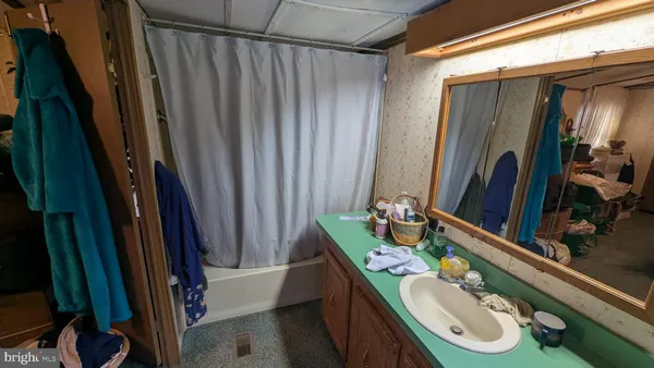 a bathroom with a sink vanity mirror and toilet