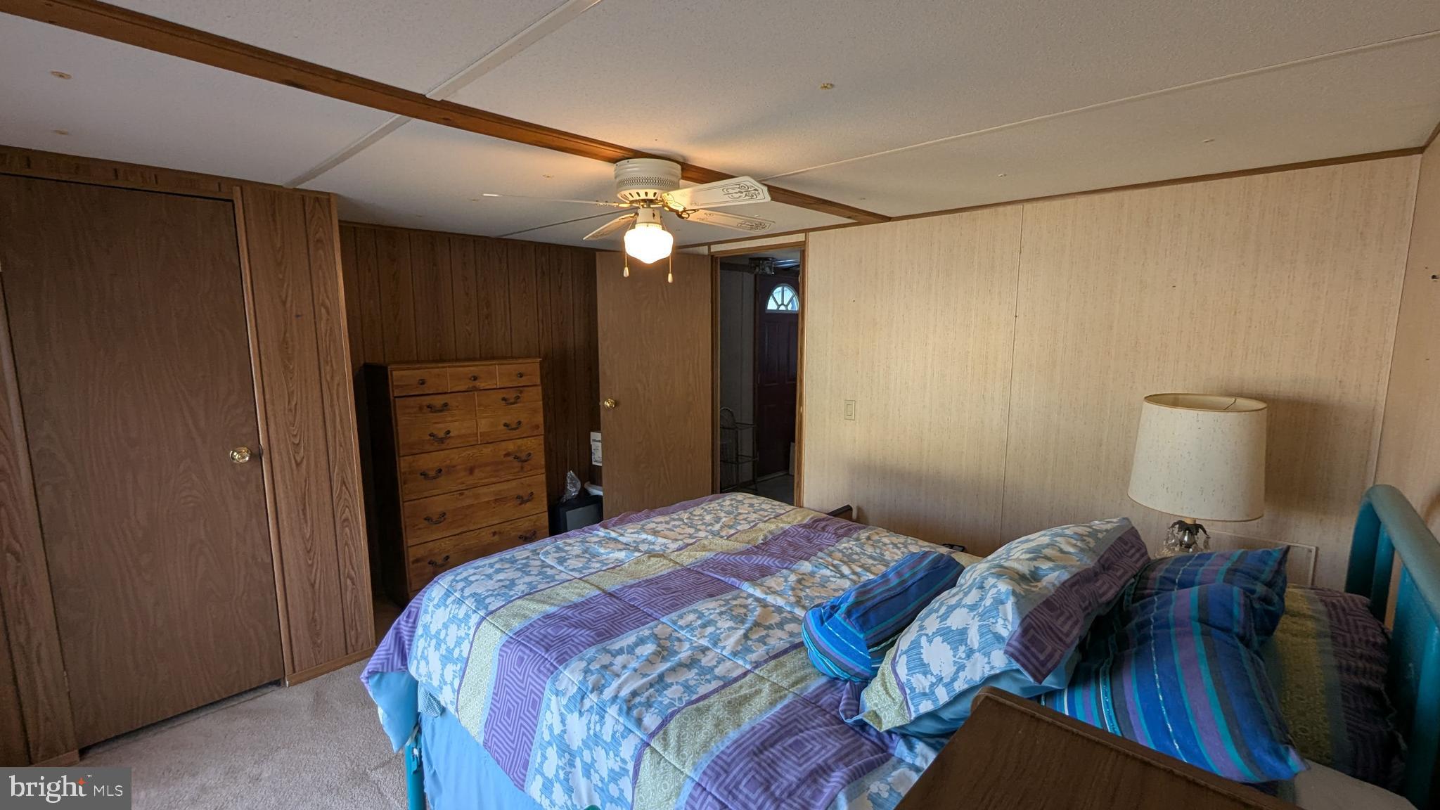 9625 Airport Road Seaford, DE 19973 - Photo 16 of 31 a bedroom with a bed and a chandelier