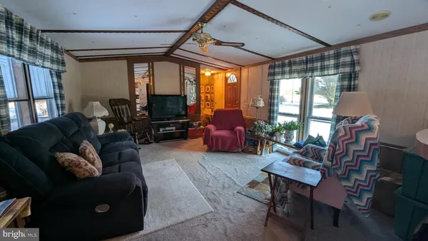 a living room with furniture fireplace and a large window