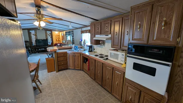 a view of a kitchen with dining table and chairs