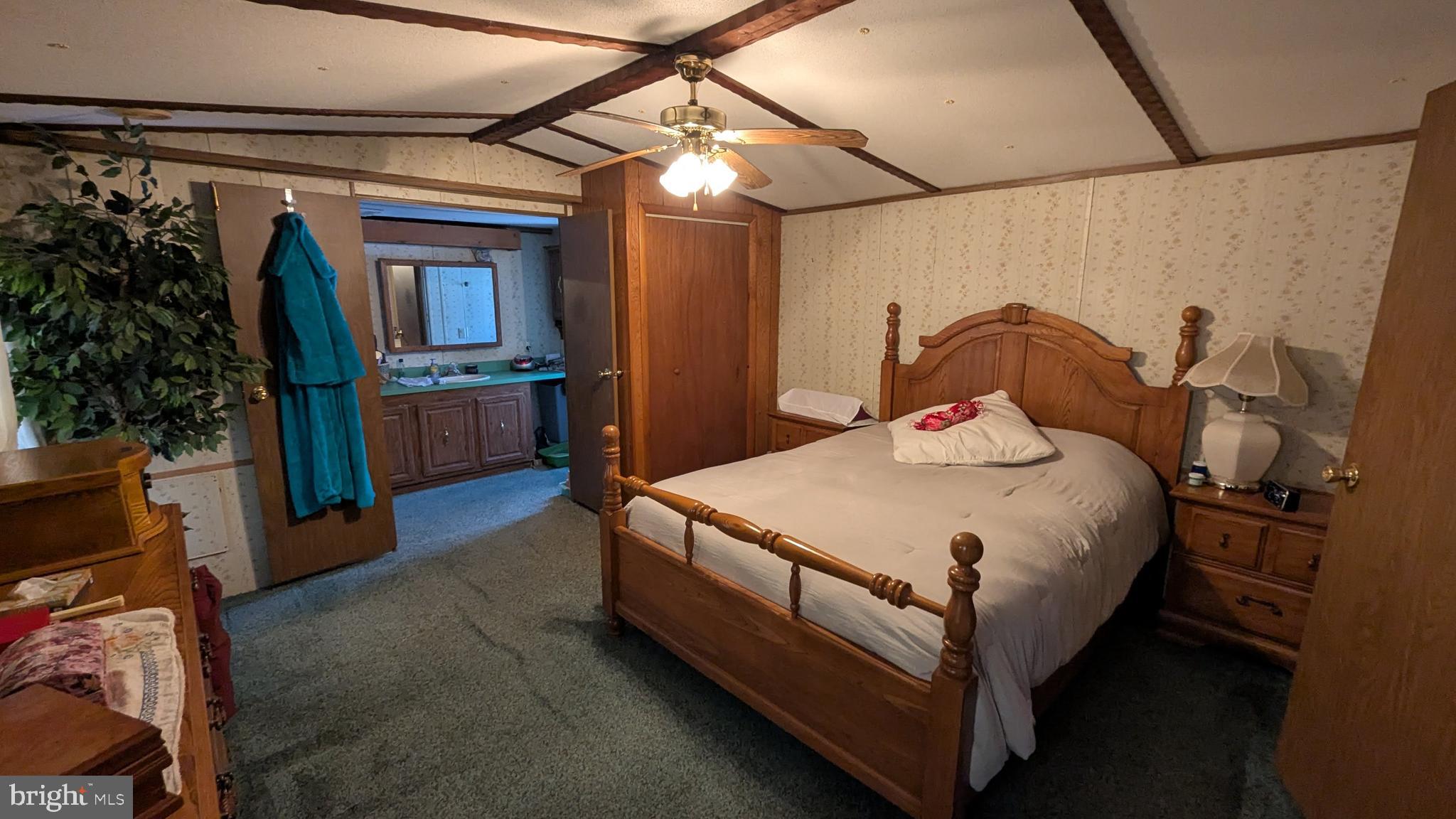 9625 Airport Road Seaford, DE 19973 - Photo 10 of 31 a bedroom with a bed and a potted plant