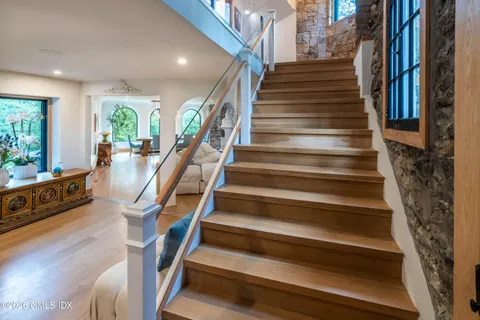 a view of entryway and hall with wooden floor