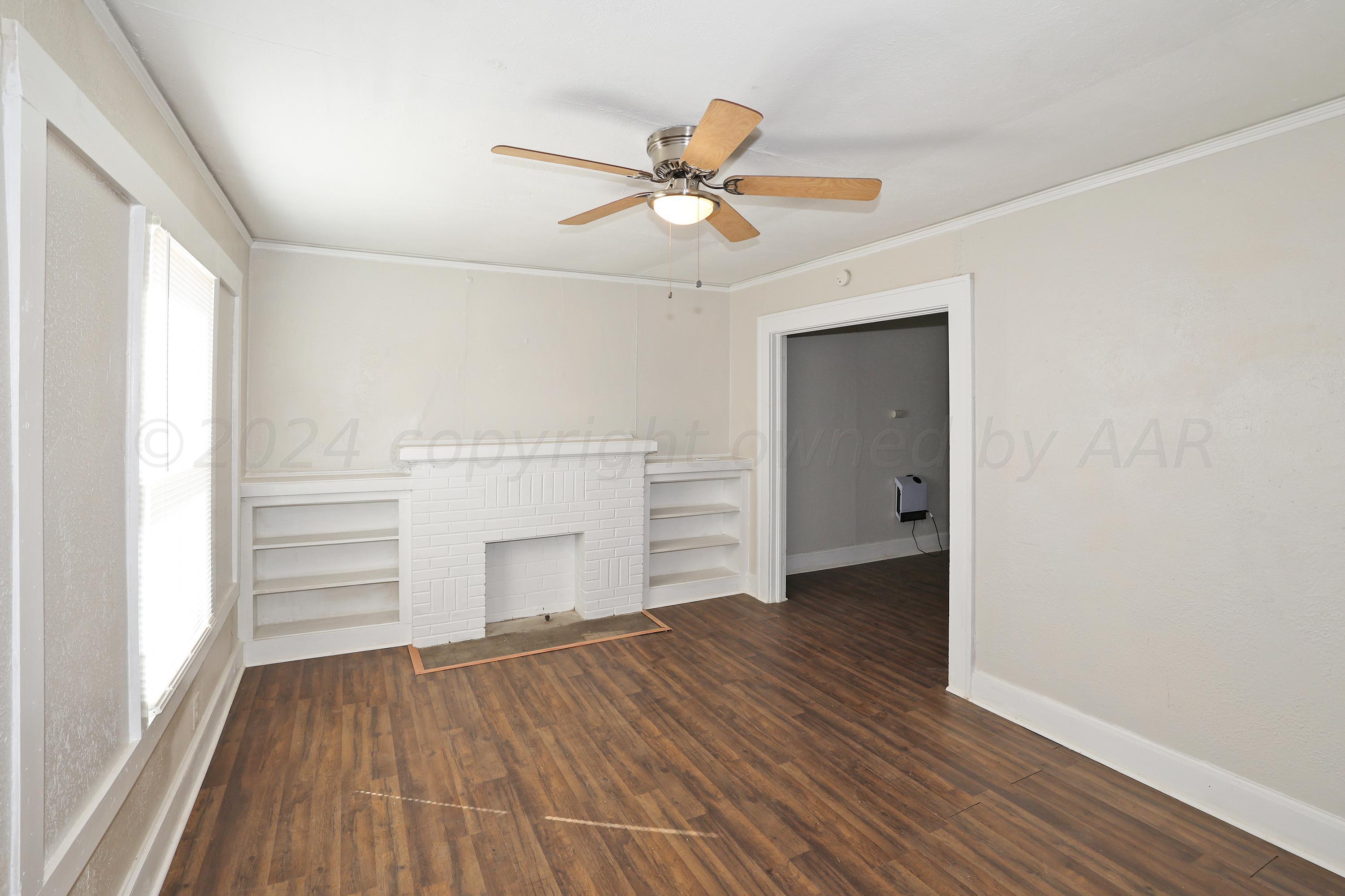 1506 Southwest 11th Avenue Amarillo, TX 79101 - Photo 2 of 10 wooden floor in an empty room with a window