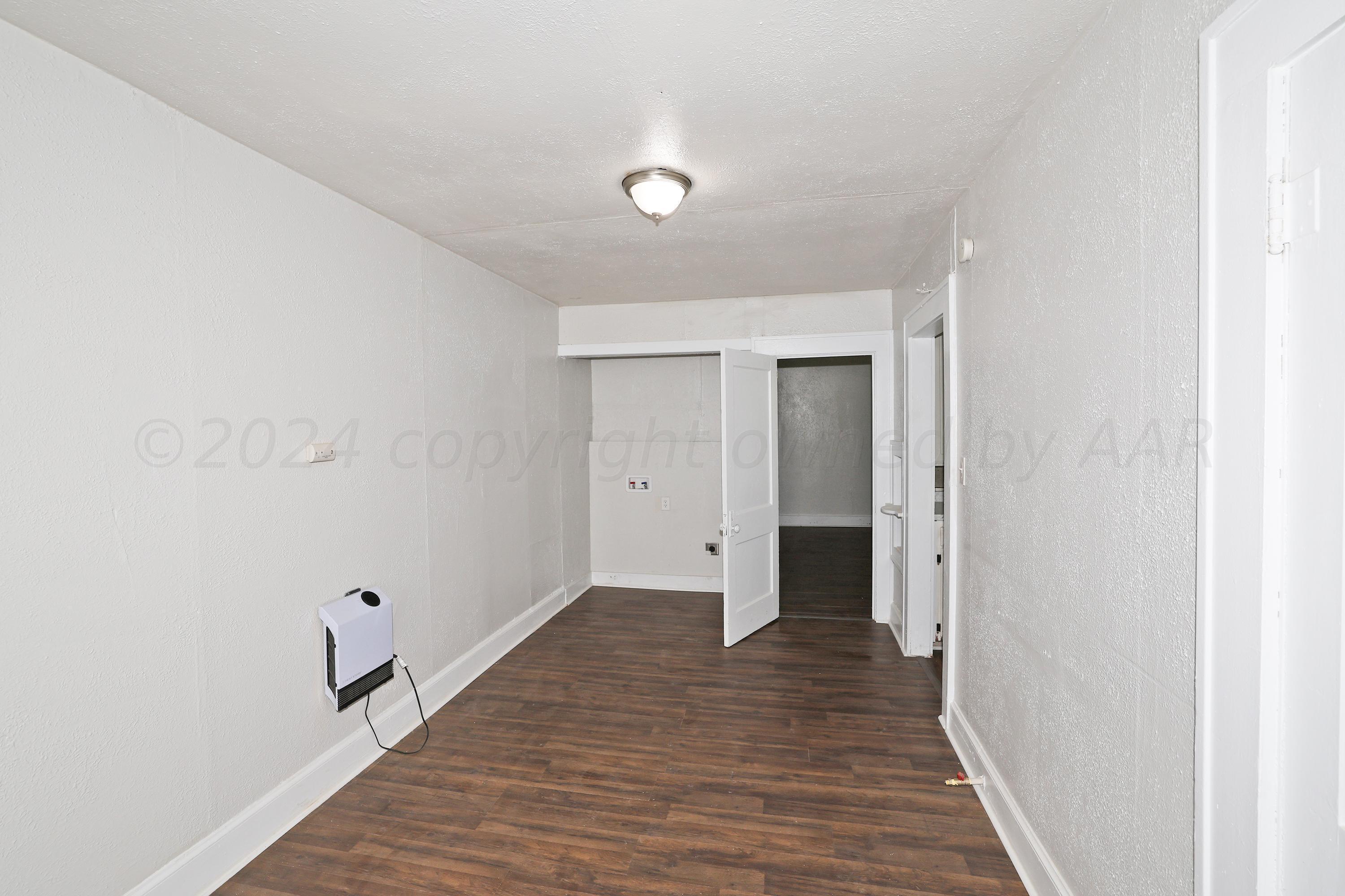 1506 Southwest 11th Avenue Amarillo, TX 79101 - Photo 4 of 10 a view of a hallway with wooden floor