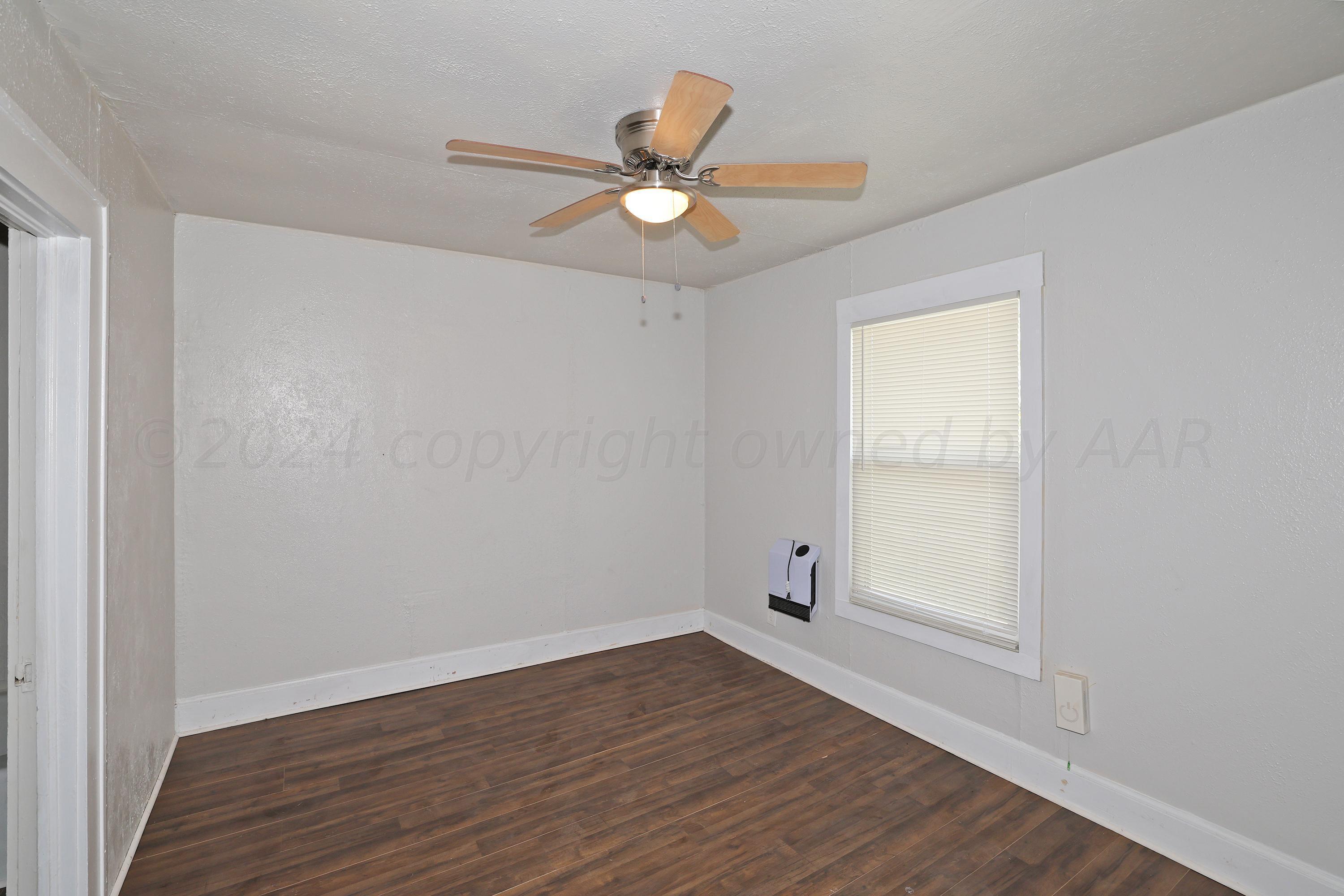 1506 Southwest 11th Avenue Amarillo, TX 79101 - Photo 6 of 10 wooden floor in an empty room with a window