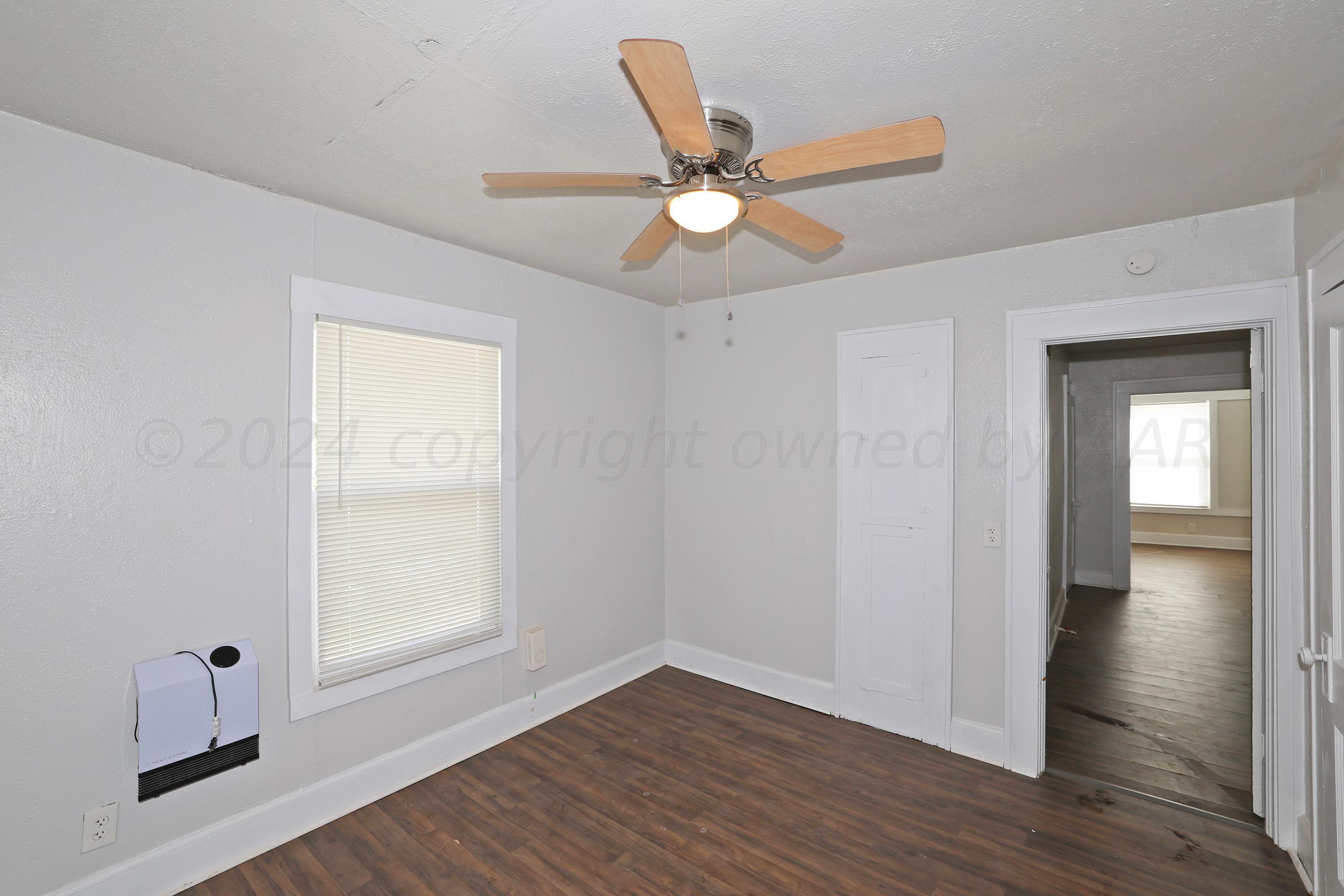 1506 Southwest 11th Avenue Amarillo, TX 79101 - Photo 7 of 10 wooden floor in an empty room with a window