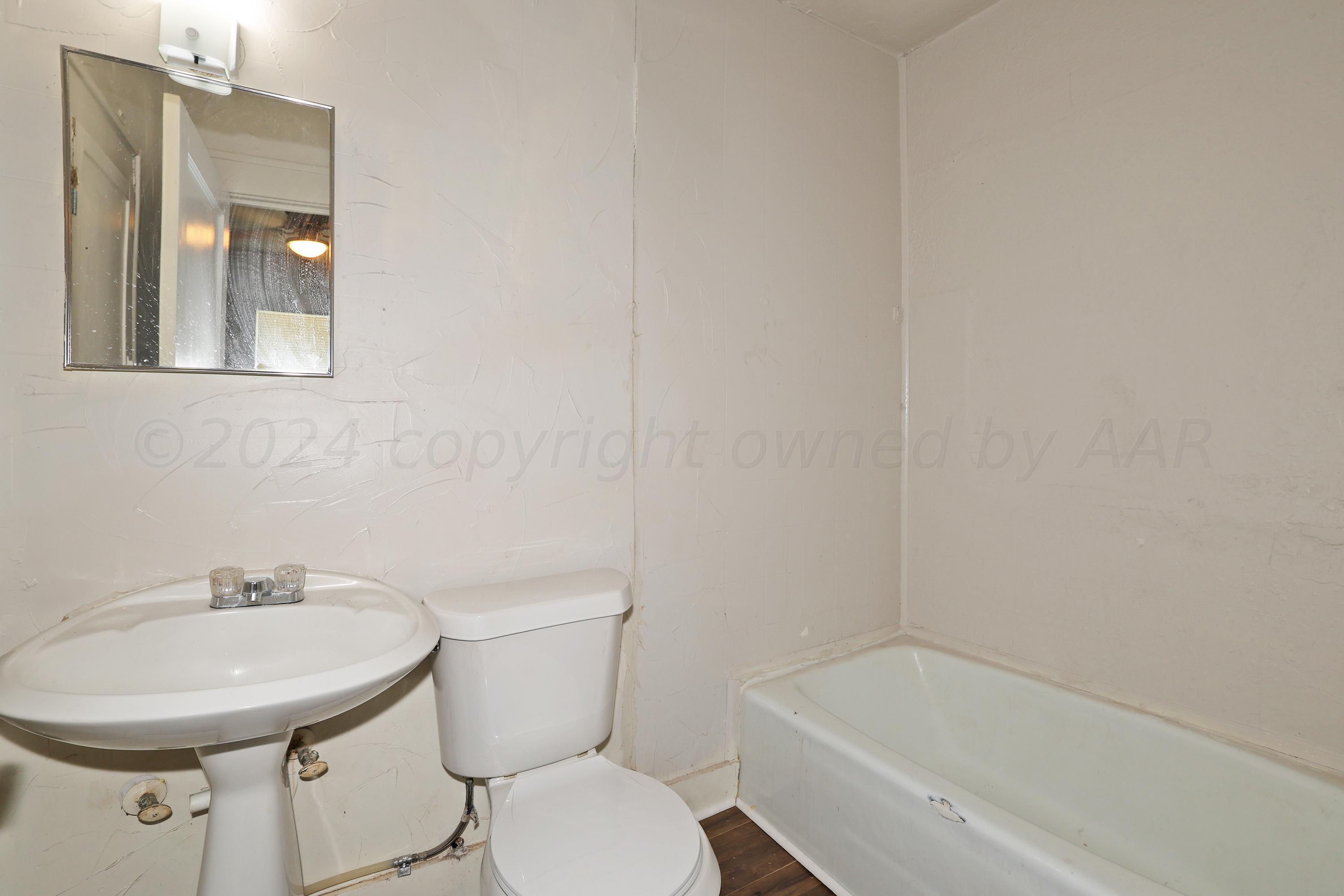1506 Southwest 11th Avenue Amarillo, TX 79101 - Photo 8 of 10 a bathroom with a sink a toilet and a bathtub