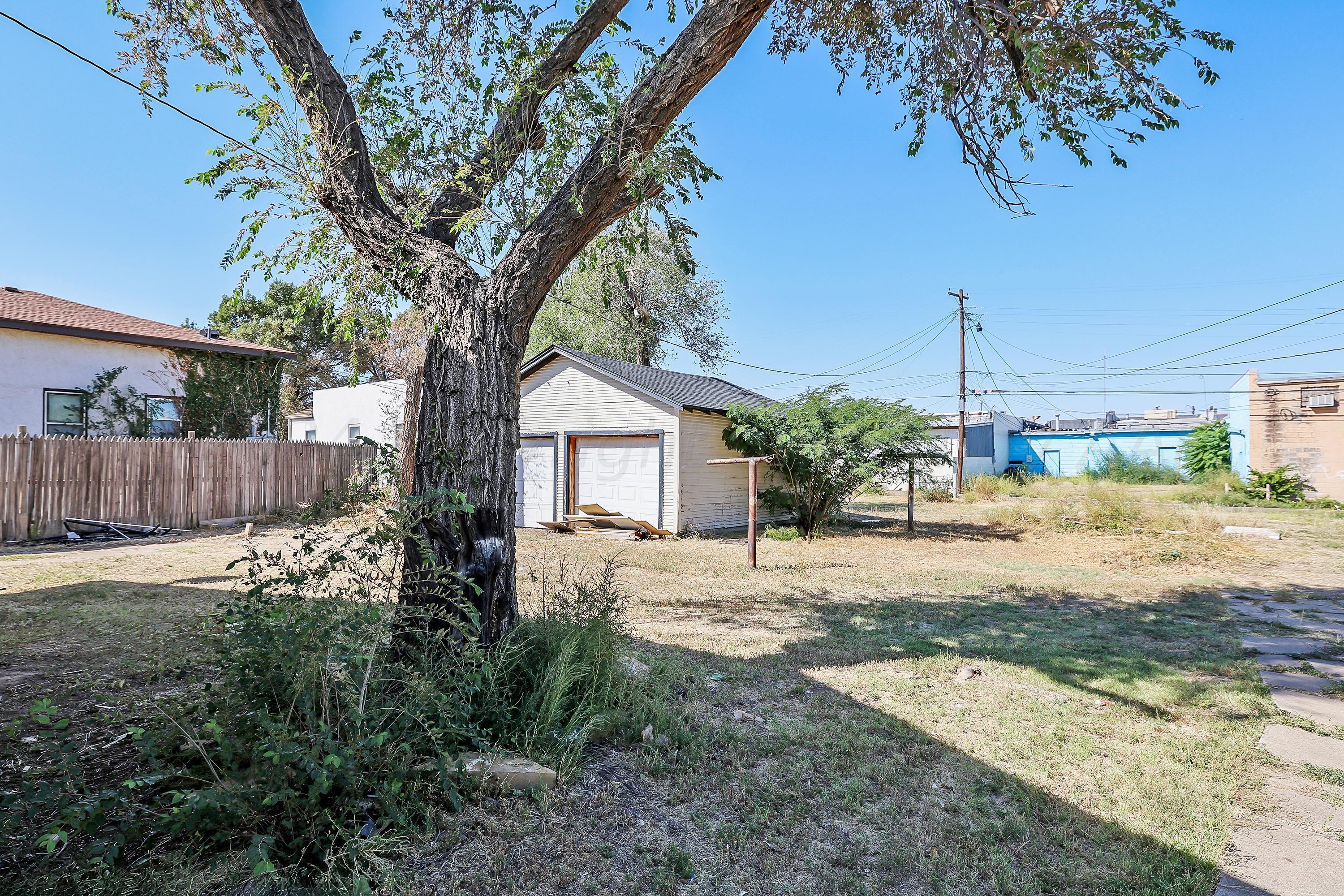 1506 Southwest 11th Avenue Amarillo, TX 79101 - Photo 10 of 10 a tree in front of a house with wooden fence