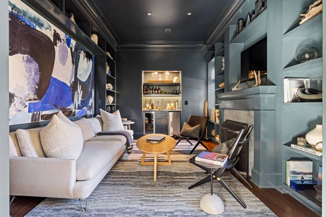 a living room with furniture a fireplace and a flat screen tv