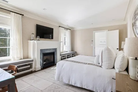 a bedroom with a bed and a fireplace