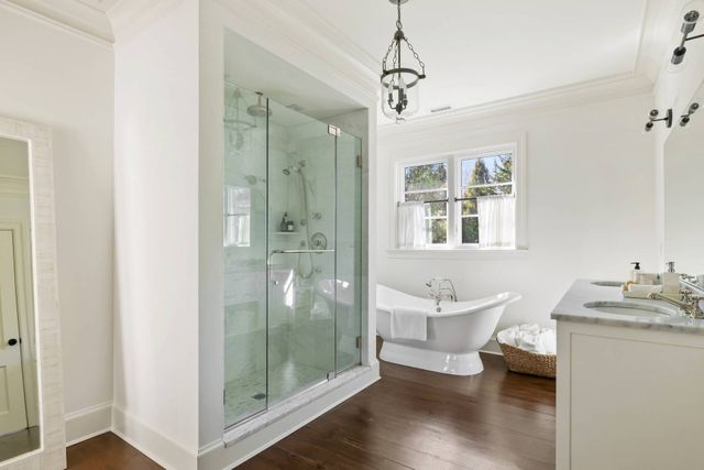 a spacious bathroom with a shower sink and mirror