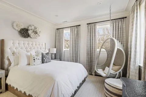 a bedroom with a bed couch and a window