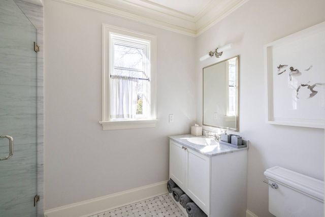 a bathroom with a sink toilet and window