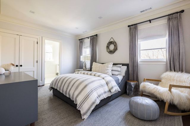 a bedroom with bed and a window