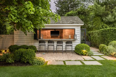 a front view of a house with a garden