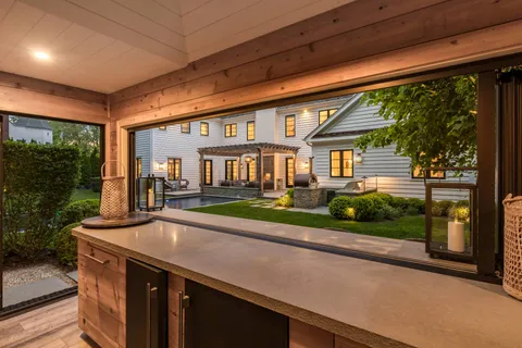 a front view of a house with porch and garden