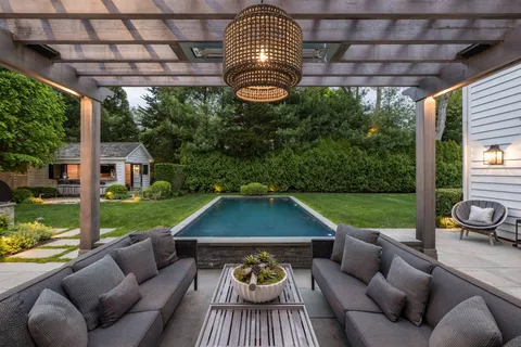 a view of a patio with couches chairs and a yard
