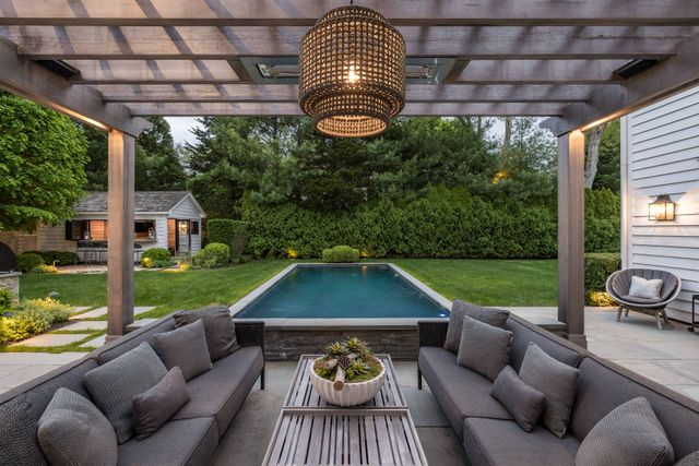 a view of a patio with couches chairs and a yard