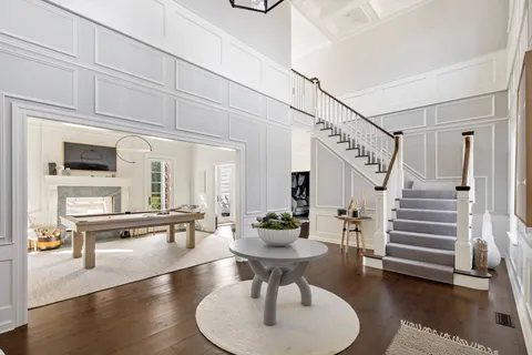 a dining room with furniture and a chandelier