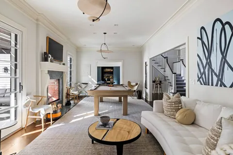 a living room with furniture a fireplace and a flat screen tv