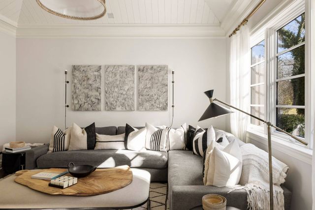 a living room with furniture and a floor to ceiling window