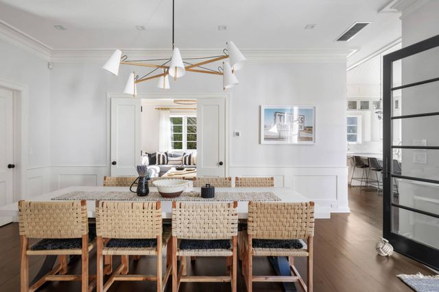 a dining room with a table chairs and a living room